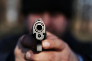 Man pointing gun directly at camera.