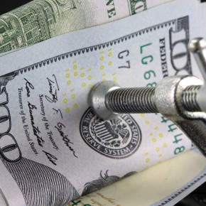 Budget Crisis US Currency one hundred dollar bill in Vise Clamp - Money is Tight Financial Concept