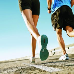 Man and woman running on a street with copyspace